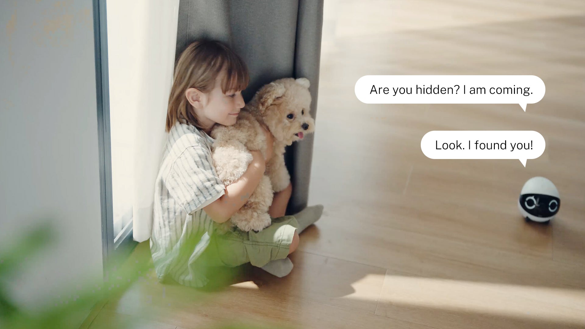 A child plays hide-and-seek with ROLA Mini, while parents interact via two-way voice and one-way video.
